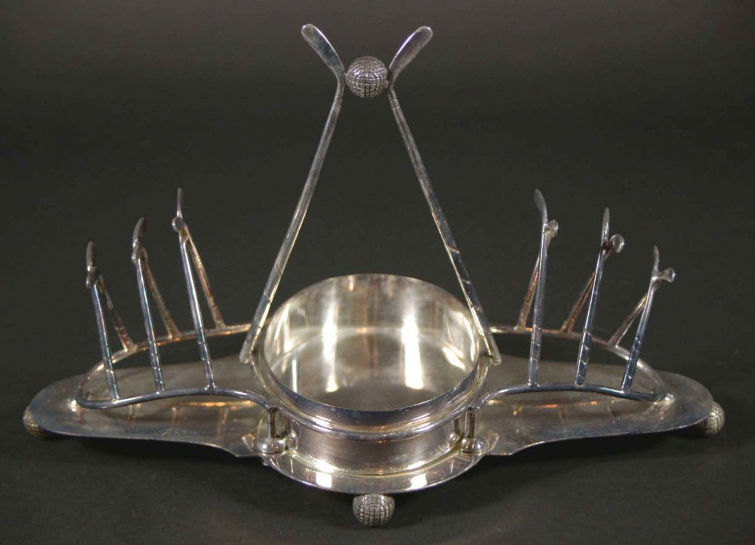 Golf Toaster Rack & Jam Dish, Hallmarked: Description: A silver plated golf theme toast rack with a holder for the butter or fruit preserves. Crossed golf clubs lined up hold the spacing for the toast. The center has 2 clubs lined up with a g