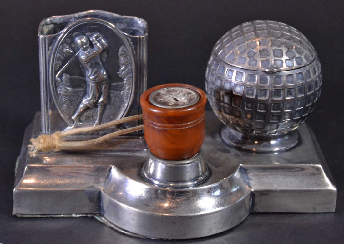 Golf Cigarette/Lighter & Elec. Lighter (wired): Description: A golf theme ashtray & cigarette holder with an electric lighter attached in silver plate. A golf ball holds the ashtray, and a man playing golf holds a pack of cigarettes. Material: Silv