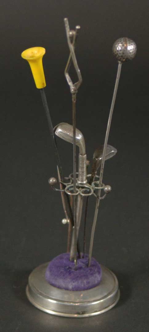 Golf Hat Pins (6) in Sterling Stand: Description: Hat pins with holder in a golf theme, the hat pins are in the shape of golf clubs, and the holders are a pin cushion with golf clubs surrounding it. Material: Sterling Maker/Artist: Unkno
