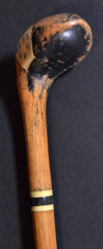 Golf Sunday Stick Cane Hickory shaft, c1920: Description: A golfing Sunday stick, with a celluloid and silver inlay head, the ferrule is silver plated. The Sunday stick is also a cane/ walking stick Material: Hickory Maker/Artist: Unknown Date: