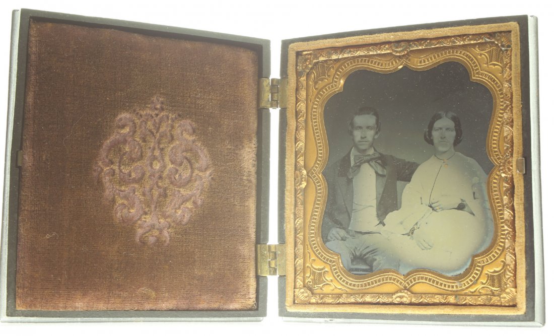 1/6 plate ambrotype: Description: Plate Size: 1/6 platePhoto type: AmbrotypePhotographer: Unknown Hand Coloration: Cheeks and accessories/giltSubject Matter: Couple seatedCase Name: Wheel of CornucopiasCase Type/Maker: Li