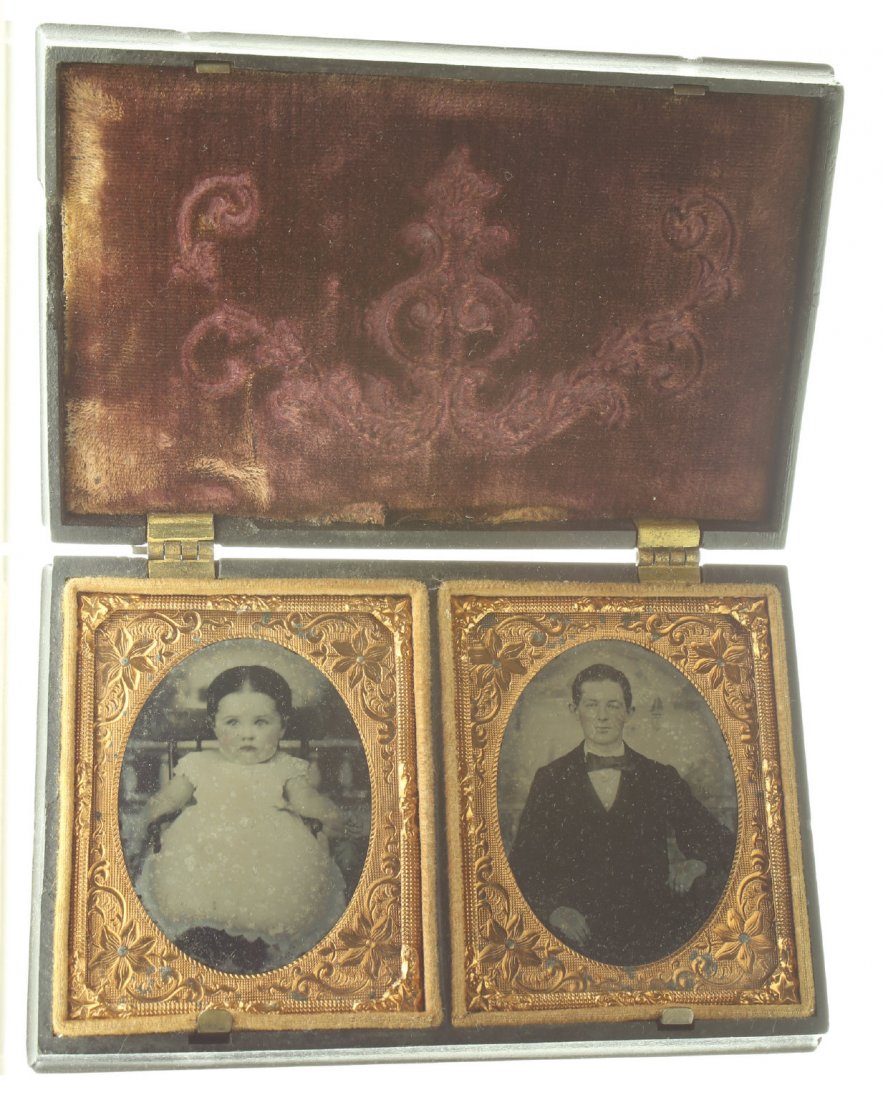 1/9 pair of plate ambrotype: Description: Plate Size: 1/9 pair of plates Photo type: AmbrotypePhotographer: Unknown Hand Coloration: Cheeks/giltSubject Matter: Baby and manCase Name: Seated Woman Holdign Child and PetsCase Type/M