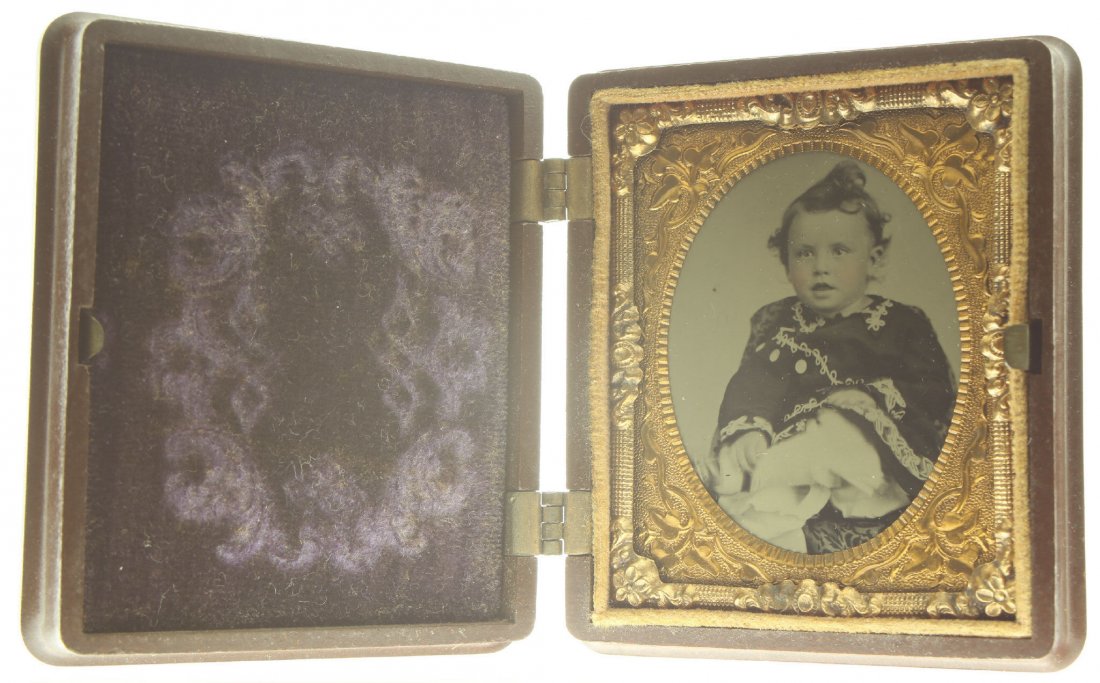 1/9 plate ambrotype: Description: Plate Size: 1/9 platePhoto type: AmbrotypePhotographer: Unknown Hand Coloration: Cheeks/giltSubject Matter: Baby boyCase Name: Floral MotifCase Type/Maker: Scovill Mfg. Co., Plastic, C.18