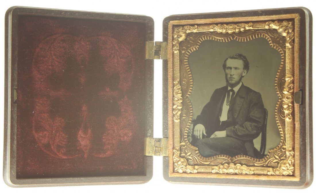 1/9 plate ambrotype: Description: Plate Size: 1/9 platePhoto type: AmbrotypePhotographer: Unknown Hand Coloration: Cheeks/giltSubject Matter: ManCase Name: Flags and ShieldCase Type/Maker: S. Peck & Co., Plastic, C. 1857.