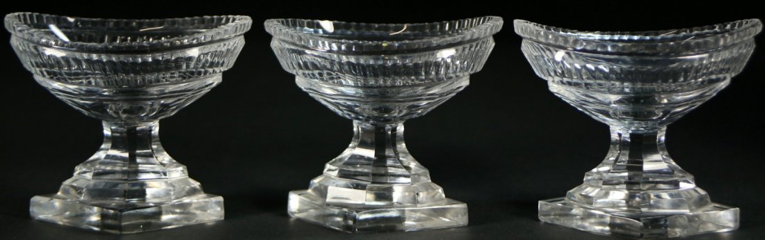 Open Salt Cellars (3), cut crystal, c 1810: Description: A collection of open salt cellars, 3 lead crystal open salt cellars oval pedestal shaped with a crystal sawtooth cut border around the top of the oval. Material: Crystal Maker/Artist: Unk