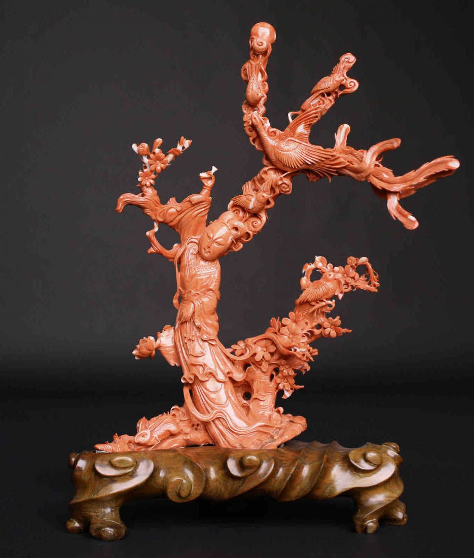 Magnificent Red Coral carving, Guan Yin: Description: Quan or Guan Yin red coral carving mounted on a later carved rosewood base. Central figure of Guan Yin holding an ingzhi scepter surrounded by nature, phoenix bird above her head with fou