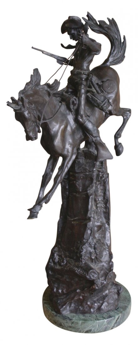 A bronze Cavalryman with U.S. on canteen: Description: A bronze figure by Carl Kauba, called “Cowboy on a rearing horse”. It shows a cowboy sitting on a rearing horse and holding a rifle in his left hand, a canteen with the U. S. on his r