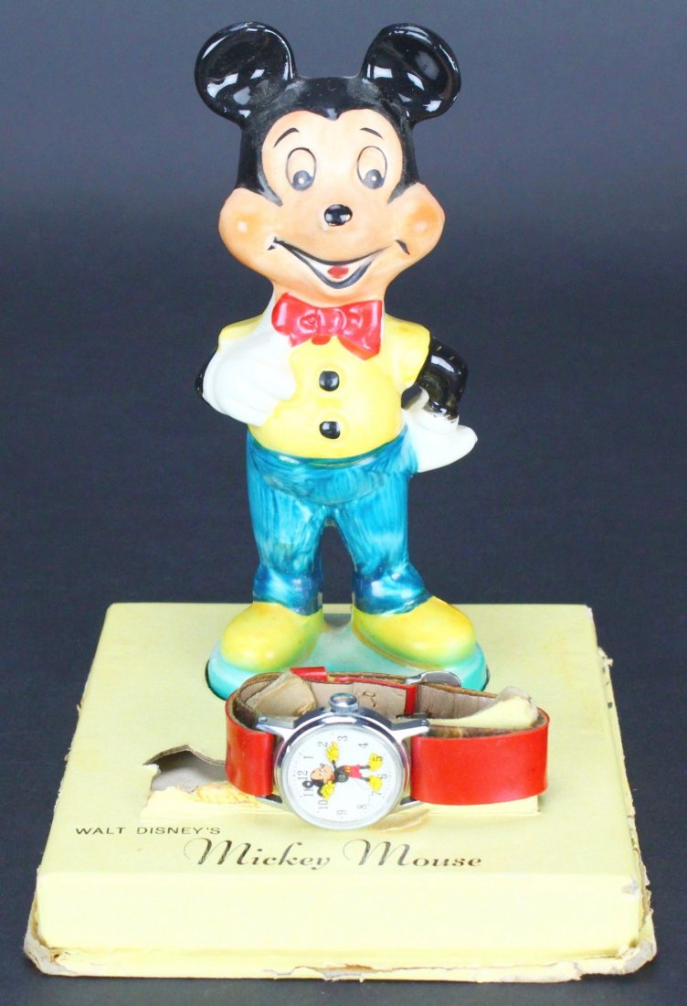 Toy, Mickey Mouse, Watch w/ Figure: Antique and Collectables Category: Toys Description: This red leather-banded wrist watch has Mickey Mouse on the face, his arms counting the time. It comes on a stand with a plastic statue of Mickey M