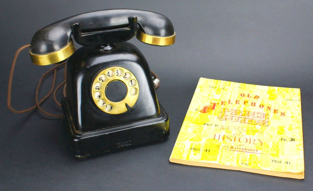 Phone, Guide Book, Belgian Hotel, 1930: Antique and Collectables Category: Tools & Measuring Devices Description: This phone is black plastic with brass deco. It is a rotary phone with a cloth covered cord from phone to casing and from casi
