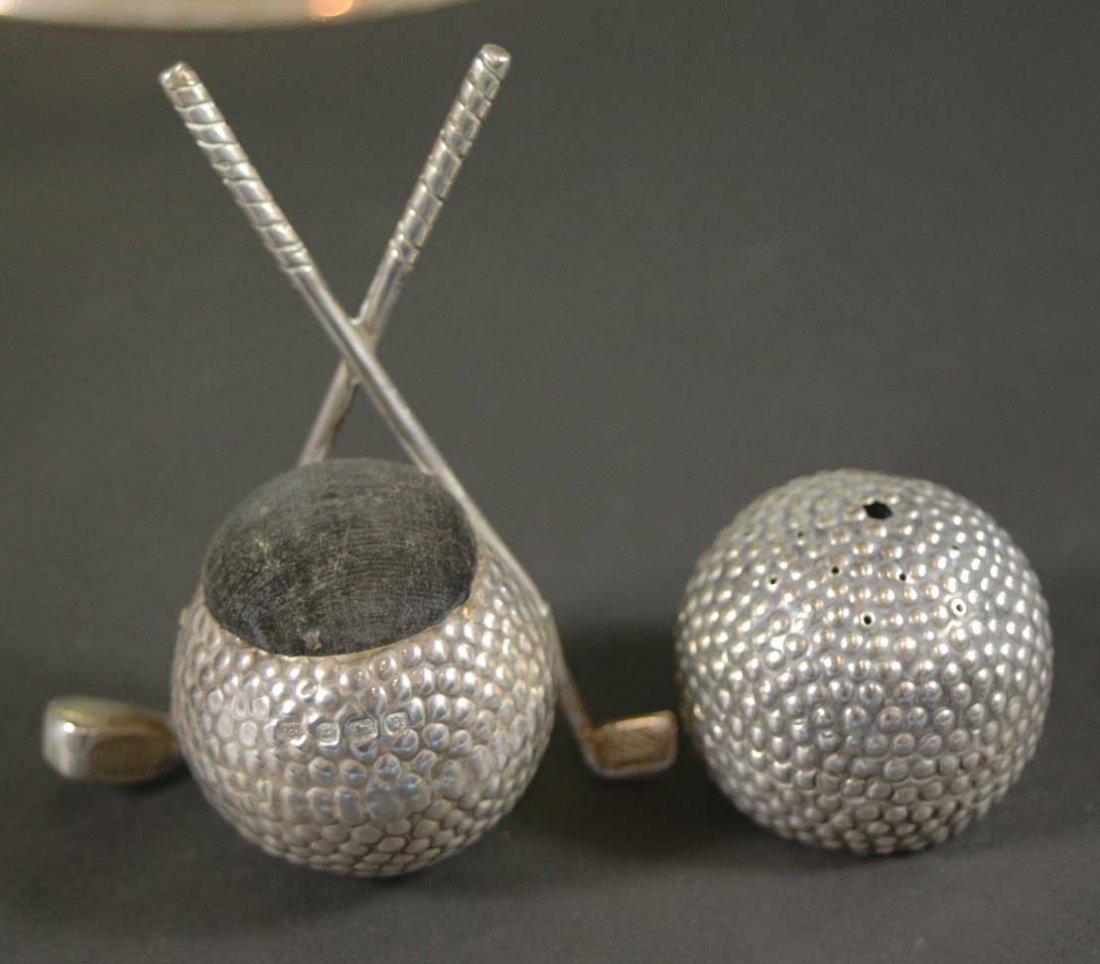Golf Pin Cushions (2) Golf Ball Motif: Antique and Collectables Category: Sports Description: A set of golf ball shaped pin cushions, one pin cushion has crossed clubs. Material: Silver plate Maker/Artist: Unknown Date: Circa 1900 Provenan