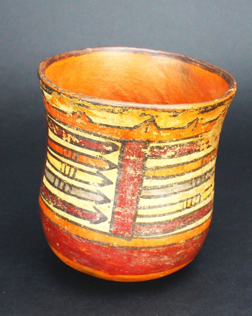 Beaker, Nazca, Peru 100 B.C. - 300 A.D.: Antique and Collectables Category: Pre-Columbian Description: The exterior of this beaker is designed with a series ofarrows in red, orange, and grey on a white background, all outlines in black. Mate