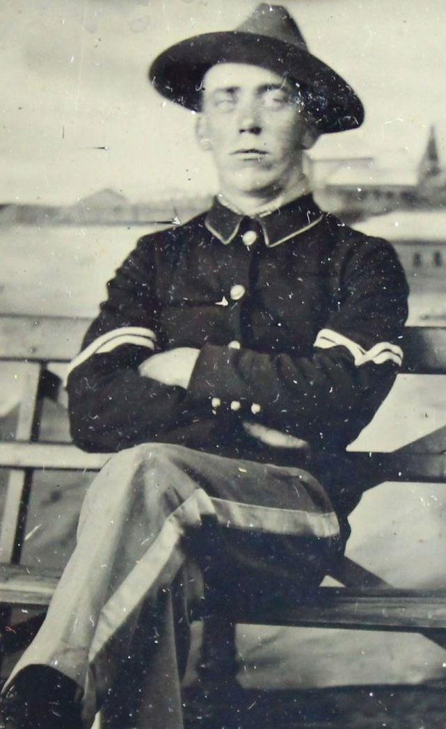 Tintype, Post Civil War, Sixth Plate: Antique and Collectables Category: Photographia Description: This portrait is of a young soldier sitting on a bench. He is in full uniform, including cap. He is cross-legged with his arms folded on hi