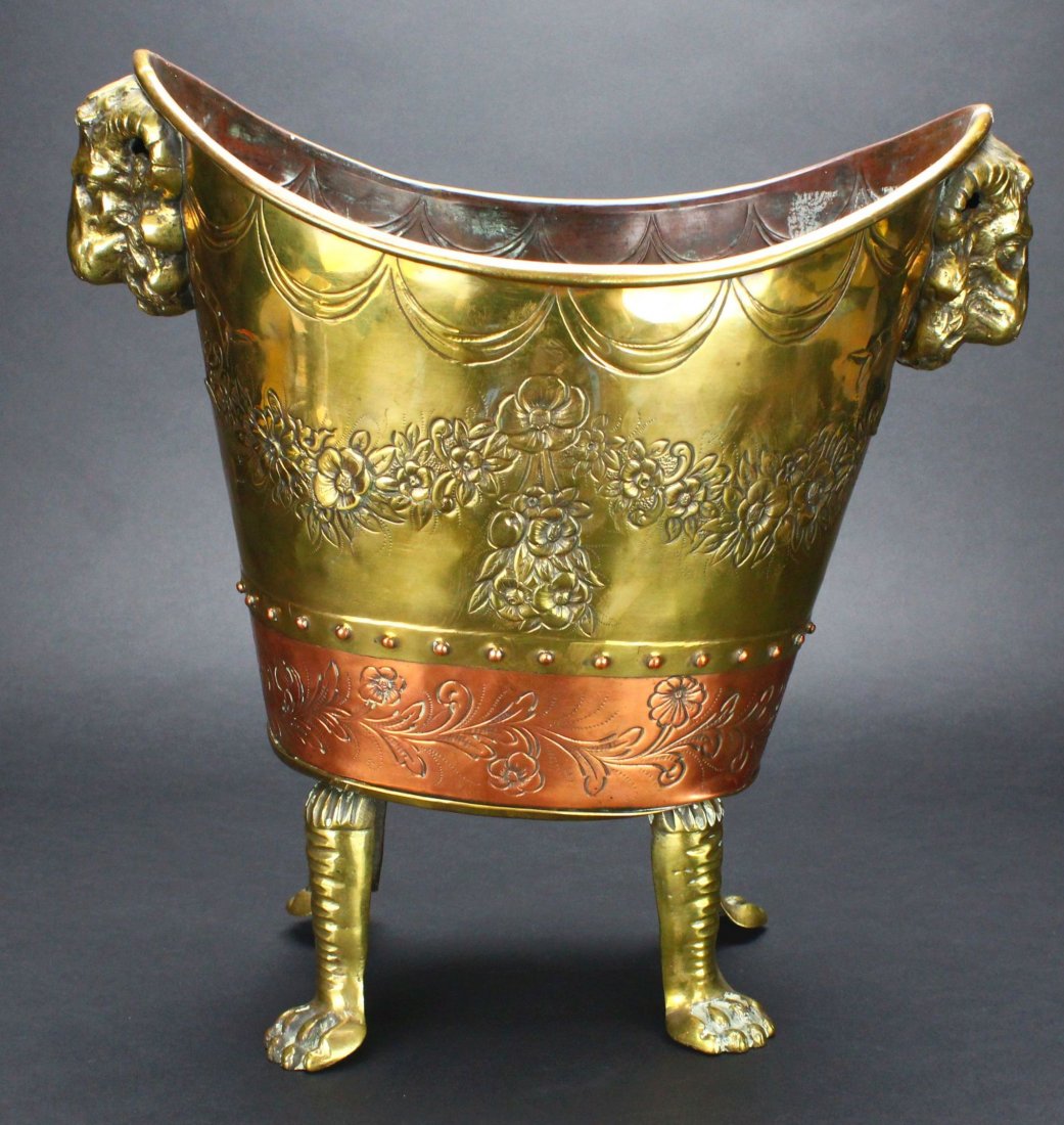 Wine Cooler, Copper and Brass, C.1840: Antique and Collectables Category: Brass Description: This wine cooler is primarily brass with a band of copper at the base, supported by brass legs ending in paw feet. At either end of the cooler nea