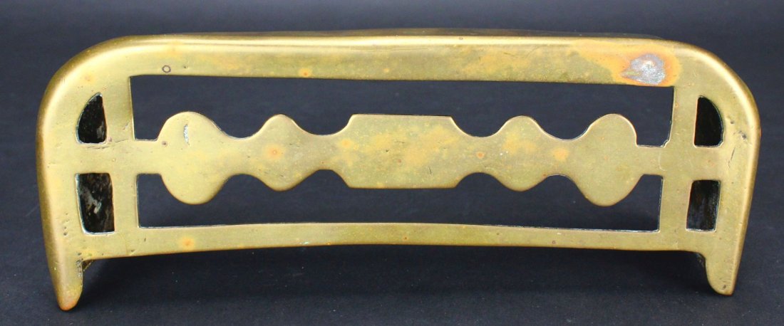 Brass, Trivet, 19th C.: Antique and Collectables Category: Brass Description: This item is made entirely of brass with three bracketing walls to let it stand freely. The top has a flowing design, carefully cut away to provid