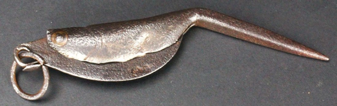 Folding Knife, Primitive, Fish Shaped: Antique and Collectables Category: Knives Description: This knife is a half-pear shape with a sharp flat edge that folds into a steel handle that is shaped like a small fish. Material: Iron/Steel Make