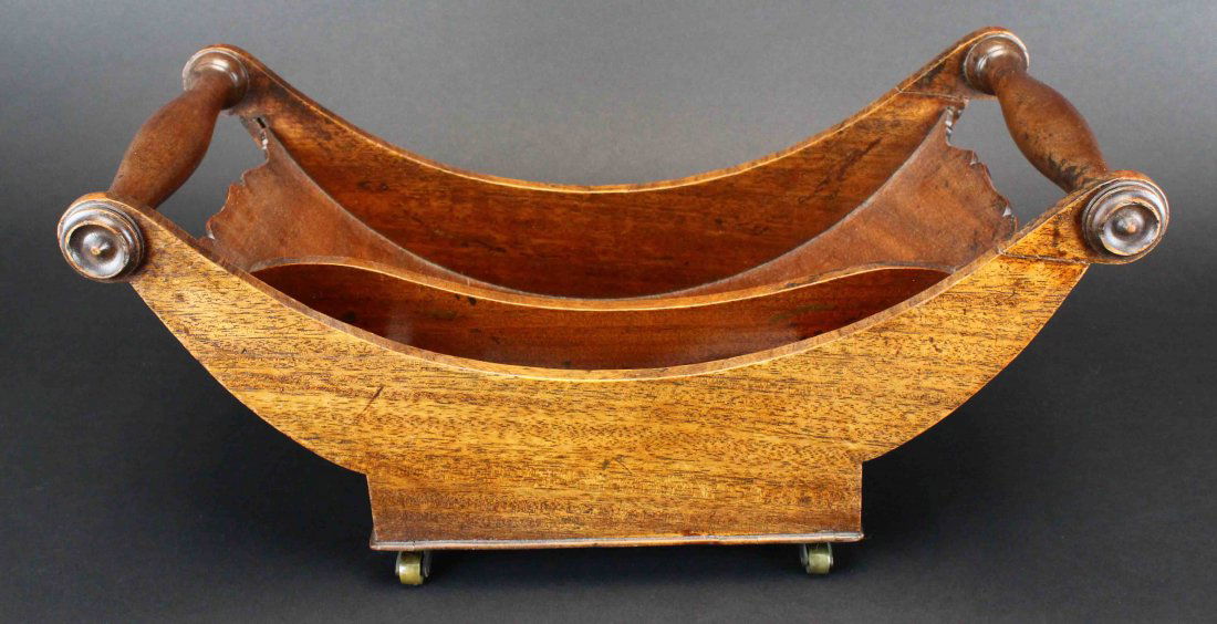 Sleigh Bed Style Basket with Casters: Description: Sleigh bed style basket with casters. This basket has a divider to partition the basket into two sections. The basket could be used to hold a variety of different household wares but was