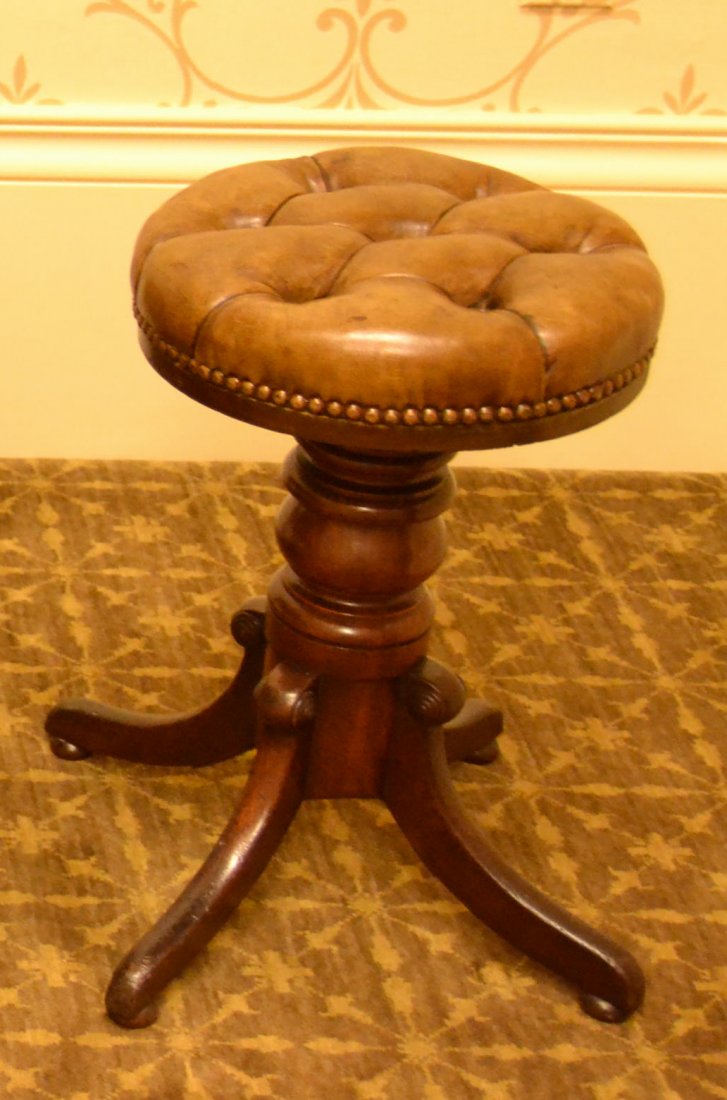 Piano Stool, Circa 1850: Description: Turned mahogany, dovetailed and iron strap joined legs, wood screw height adjustment. New tufted leather upholstery. History: N/A Provenance: Whitenack Estate of Naples, FL Dimensions: