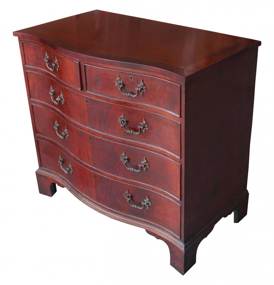 Chest of Drawers Serpentine Front: Description: Constructed of mahogany solids and veneers with oak secondary wood and featuring matched grain drawer fronts, band inlaid top and fancy brasses. History: In furniture, serpentine-front dr