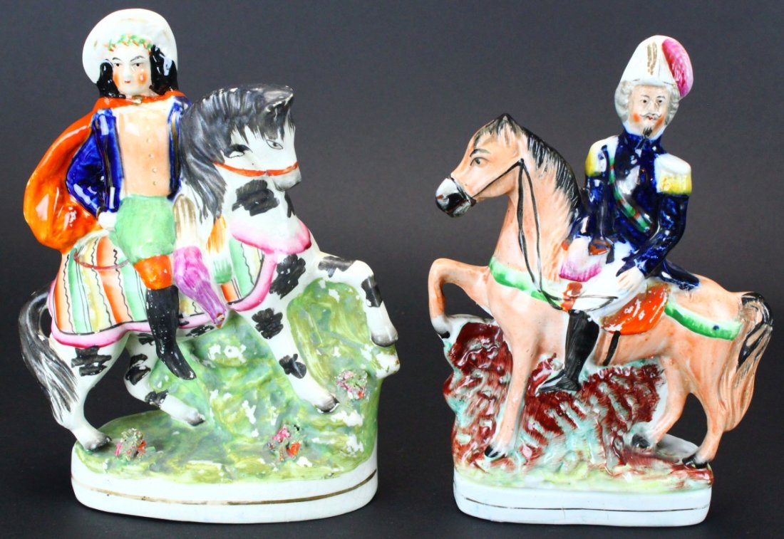 Staffordshire Figures, (2) Men On Horses: Description: (1)This figure depicts a military man on a stepping horse on a raised rectangular base. (2) A man with cape and boots with a decorated blanket on his black and white horse. History: Staff