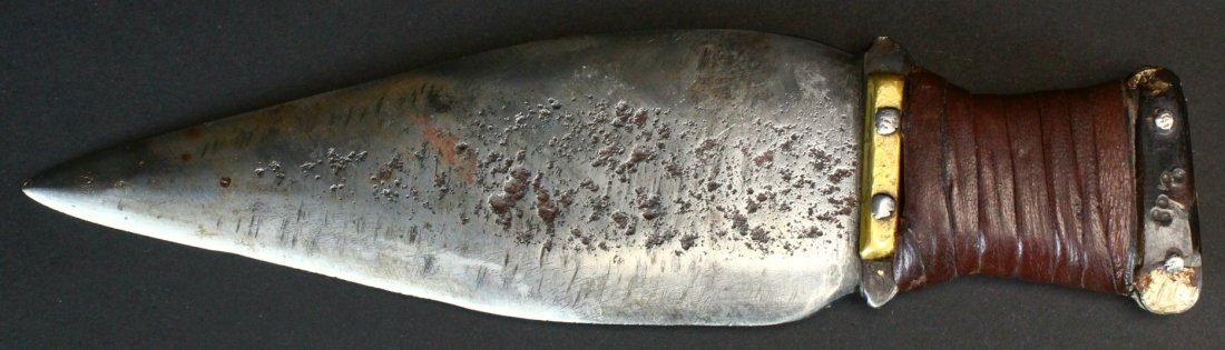 American Indian Spear Point, Circa 1850: Description: Good quality iron pounded into a 7" blade. Decorated on the ricasso with brass. On the pommel end with bone and buffalo horn. The grip is wrapped in leather. History: The knife with a spe