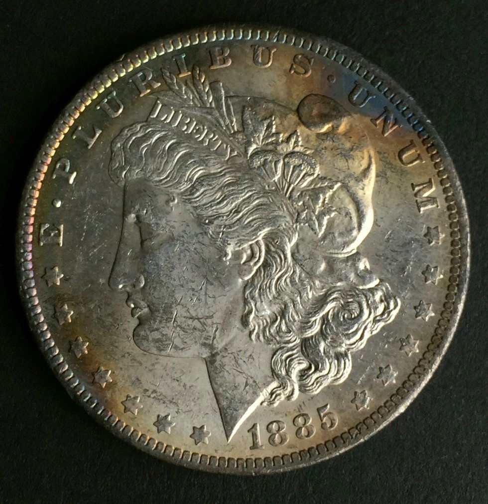 1885 Morgan, MS-65: Description: Morgan Dollar History: The Morgan dollar was a United States dollar coin minted from 1878 to 1904, and then again in 1921. It was the first standard silver dollar minted since production