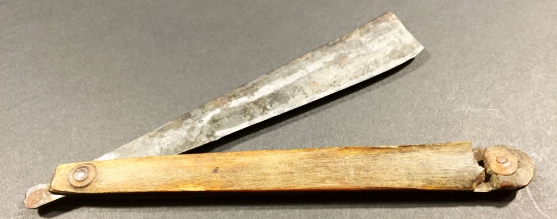 Razor, Horn Handle,18th C. French: Description: Large pin caps hold the horn handle to the steel blade of this razor. The tang of the blade is marked with a Fleur de Lis and a cursive F. History: Potentially Langlois. Provenance: N/A D