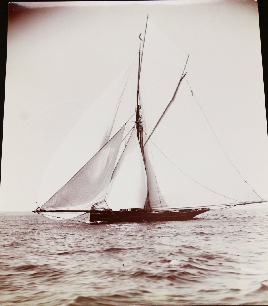 Photograph, Cutter Bederna, C. 1900: Description: This photograph is of a cutter with a large sail known as a Spinnaker. It sits on the water, fully sailed. History: Unknown Provenance: N/A Dimensions: Weight (Pounds & Ounces) = 0.018