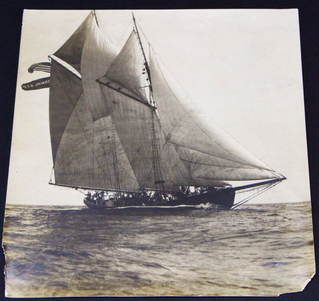 Photograph, Morning Star, Ship, C. 1880: Description: This picture shows a fully crewed ship at full mast, cutting through the waters. Two flags are visible behind the sails, an American flag and one stating the name of the ship, cut off to