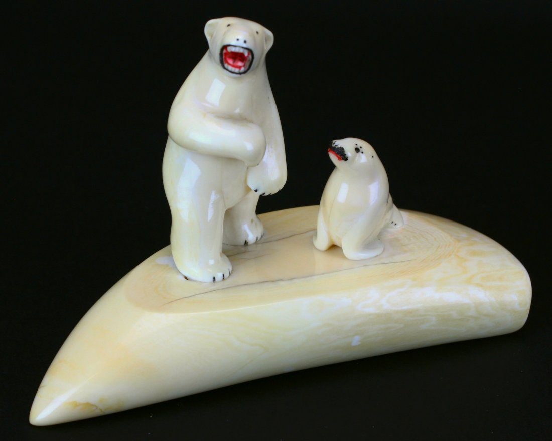 Whale Tooth Carving, Polar Bear and Seal: Description: Antique whale's tooth carving of a polar bear and seal standing on a tooth. Painted red and black features. History: Ivory statue is the carving of ivory, that is to say animal tooth or t