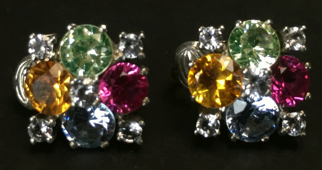 Earrings, Silver, Colored Stones: Description: A pair of square shaped sterling silver clip on earrings. Multi colored glass stones in brilliant gem cuts, .5 x.5". History: The era we now know as â€œArt Decoâ€ received its mo