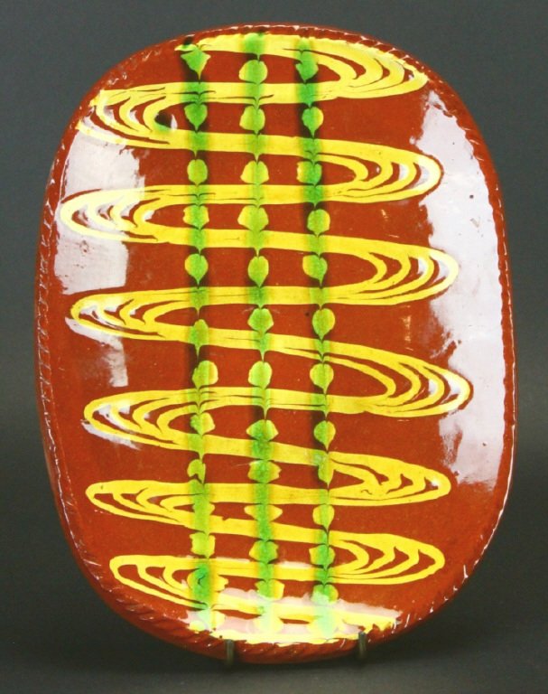 Large Redware Sgraffito Pottery Tray: Description: Large Redware Sgraffito Pottery Tray. Brown slipcoat with yellow and green sgraffito designs. Nice rim detail. Signed with maker in oval mark and also incised MMA. History: N/A Provenance