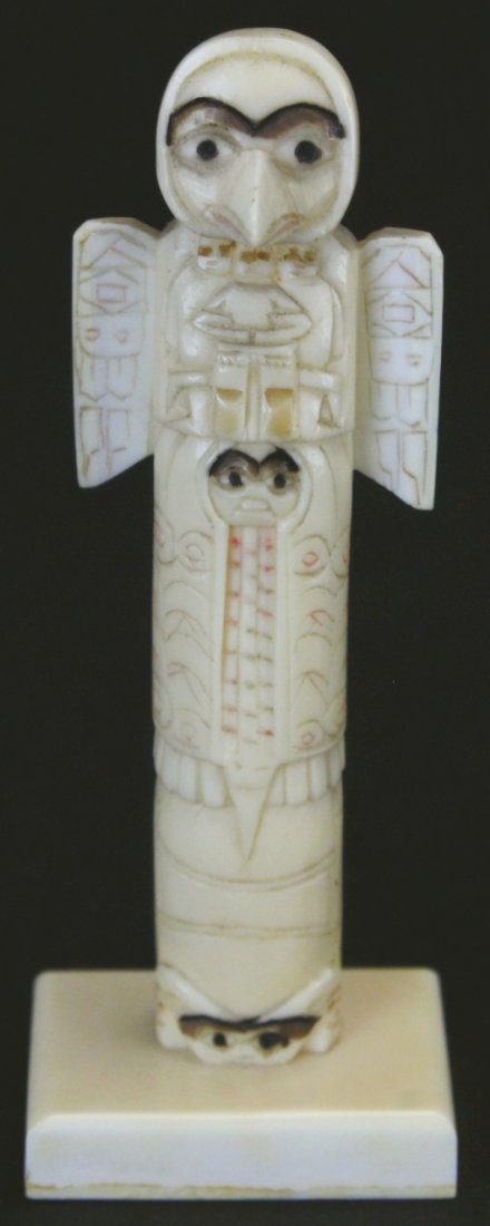 Walrus Ivory Carving, Totem Pole: Description: Eskimo totem pole carved from walrus ivory. Very rare, as 99% of small totem poles are carved from bone. History: Inuit art refers to artwork produced by Inuit people, that is, the people
