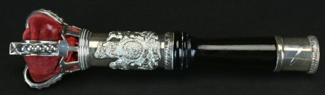 Tipstaff, Silver and Ebony, 1972: An ebony shaft covered at the top and bottom with silver hallmarked by Wakely & Wheeler, London, 1972. The arms attached to the shaft and the crown of Great Britain contain red velvet.