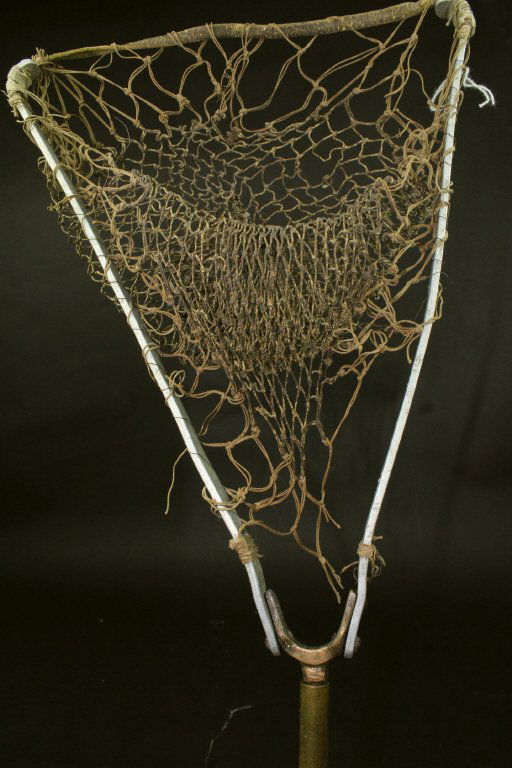 Gadget Cane, Beech, Fishnet, 20th C.: This beech cane or walking stick has a collapsible net attachment that can be affixed to the bottom. It measures 17.0 x 11.75 x 0.75" when extended. The grip is a brass sphere.