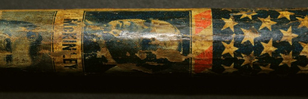 Cane, McKinley, Roosevelt, C. 1901: This campaign cane or walking stick has been painted in the colors of the United States, with a print of President McKinley and Vice President Roosevelt a third of the way down the cane.