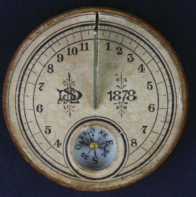 Sundial, Portable, Sullivan Solargraph, 1878: This portable sundial has a built-in compass to help orient the sundial for the most accurate reading. It has a beech body with an iron fin. The bottom of the dial has instructions for use in addition