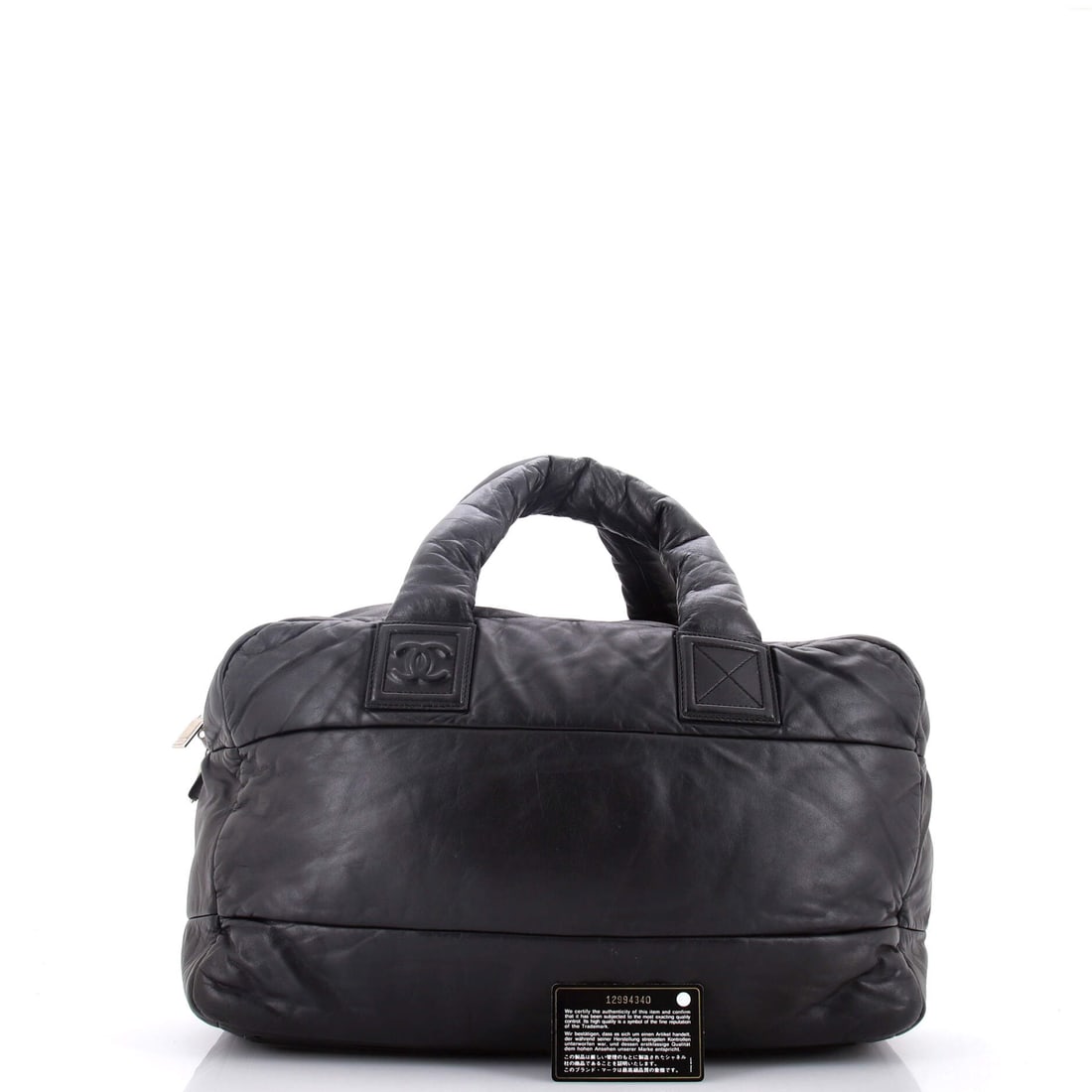 Chanel Coco Cocoon Bowling Bag Quilted Lambskin Large: Masterfully designed by Chanel, this arm candy is pure editorial gold. Featuring the iconic Chanel Coco Cocoon Bowling Bag Quilted Lambskin Large, its a testament to refined rebellion. The rich black