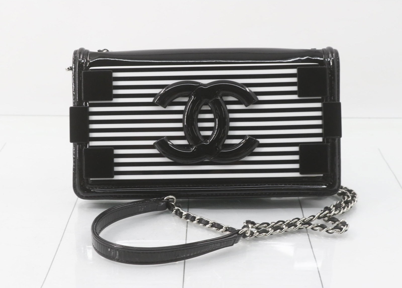 Chanel Boy Brick Flap Bag in Patent Leather and Plexiglass: A glossy little showpiece with serious attitude. The Brick Boy silhouette brings sharp lines, a structured profile, and that unmistakable Chanel edge-perfect when you want something small, sleek, and