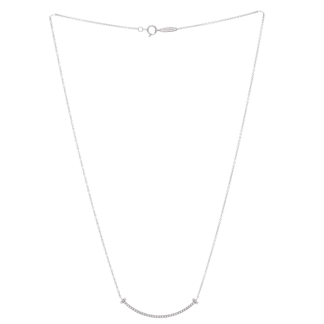 Tiffany & Co. T Smile Pendant Necklace 18K White Gold with Diamonds Small: Small-Scale Gold, White Gold necklace deserves to be carried, not kept. The Tiffany & Co. T Smile Pendant Necklace 18K White Gold with Diamonds Small in White Gold brings the quiet confidence that