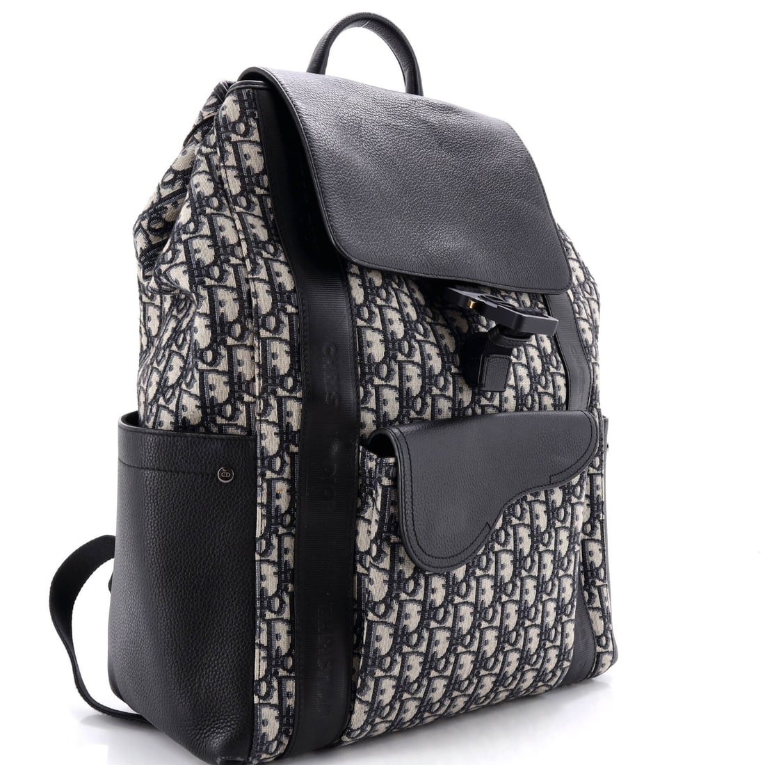 Christian Dior Saddle Pocket Backpack Oblique Canvas and Leather Large: The quietest statement is often the loudest. The Christian Dior Saddle Pocket Backpack Oblique Canvas and Leather Large in Blue -- a generously-sized Leather, Canvas backpack -- speaks entirely throug