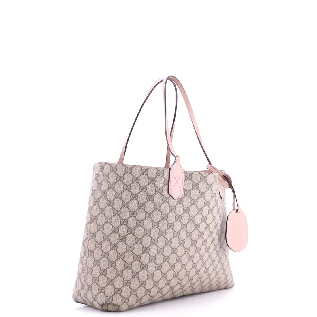 Gucci Reversible Tote GG Coated Canvas with Leather Medium: Designed for those who dress the part -- and then some. Gucci's beloved Reversible Tote GG Coated Canvas with Leather Medium in Brown, Pink leather canvas (size Medium) -- a perennial favorite for goo