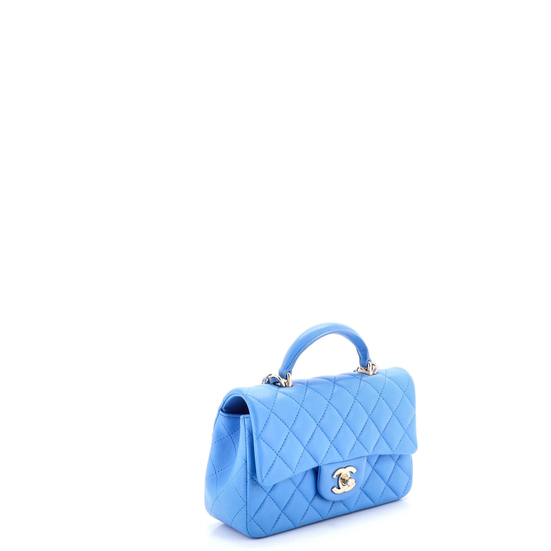 Chanel Classic Single Flap Top Handle Bag Quilted Lambskin Mini: The smallest details carry the heaviest elegance. The Chanel Classic Single Flap Top Handle Bag in Blue Quilted Lambskin unfolds like a story told in whispers. Presented in the Mini size, quilted lamb