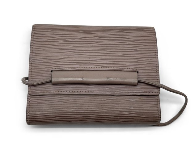 Louis Vuitton Epi Portefeuille/Wallet: Sleek Epi leather, clean lines, and a zip-around format that keeps everything in order. This wallet is the grown-up kind of luxury: understated, durable, and designed for daily use without looking lik