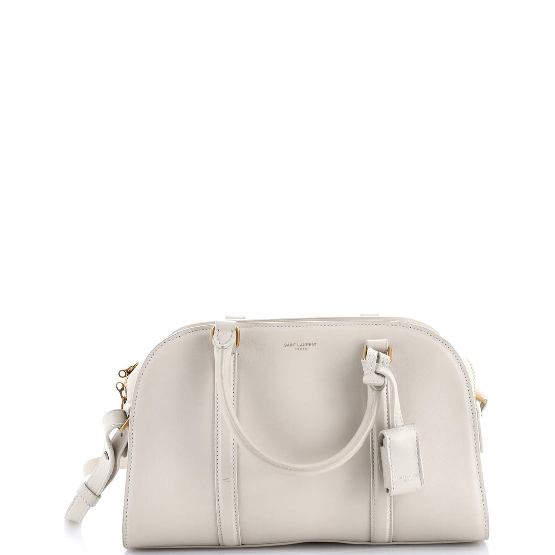 Saint Laurent Lock Baby Duffle Bag, Leather: Heritage is not loaned, it is inherited, and the Saint Laurent Lock Baby Duffle Bag in Leather carries that lineage in every detail. It belongs to a wardrobe edited by intention rather than impulse, a