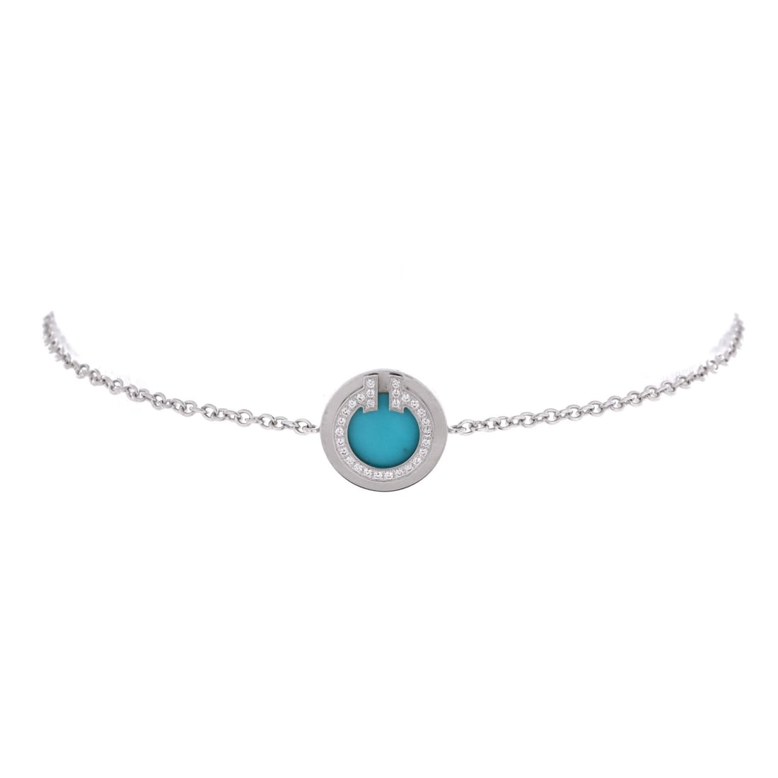 Tiffany & Co. T Circle Chain Bracelet 18K White Gold with Turquoise and Diamonds: The Tiffany & Co. T Circle Chain Bracelet, presented here in 18K White Gold with Turquoise and Diamonds, at a 6.5 inch length profile, sits comfortably between costume jewelry and statement piece. 18K