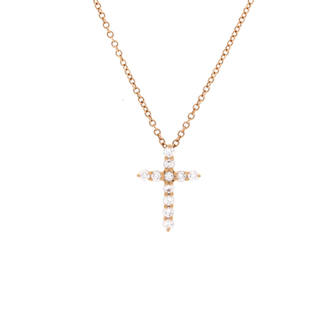 Tiffany & Co. Cross Pendant Necklace 18K Rose Gold with Diamonds (Mini): The Tiffany & Co. Cross Pendant Necklace in 18K Rose Gold with Diamonds keeps the model's design language intact while holding the model's signature scale at 16 inch length. The metalwork sits as clea
