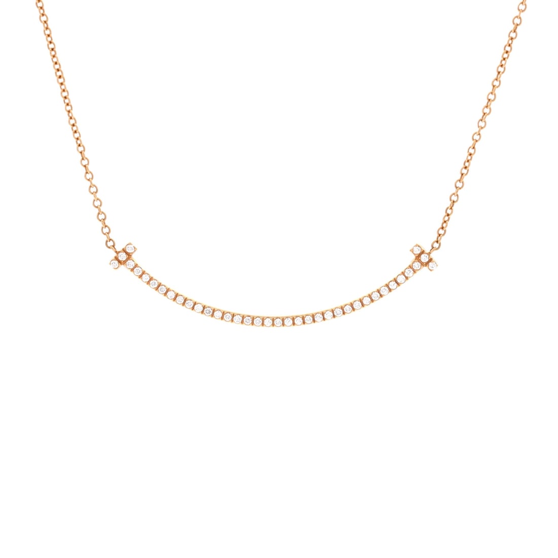 Tiffany & Co. T Smile Pendant Necklace 18K Rose Gold with Diamonds (Small): The Tiffany & Co. T Smile Pendant Necklace in 18K Rose Gold with Diamonds is the model in its most quietly photographed configuration, at a 15.8 inch length profile. The 18k rose gold with diamonds su