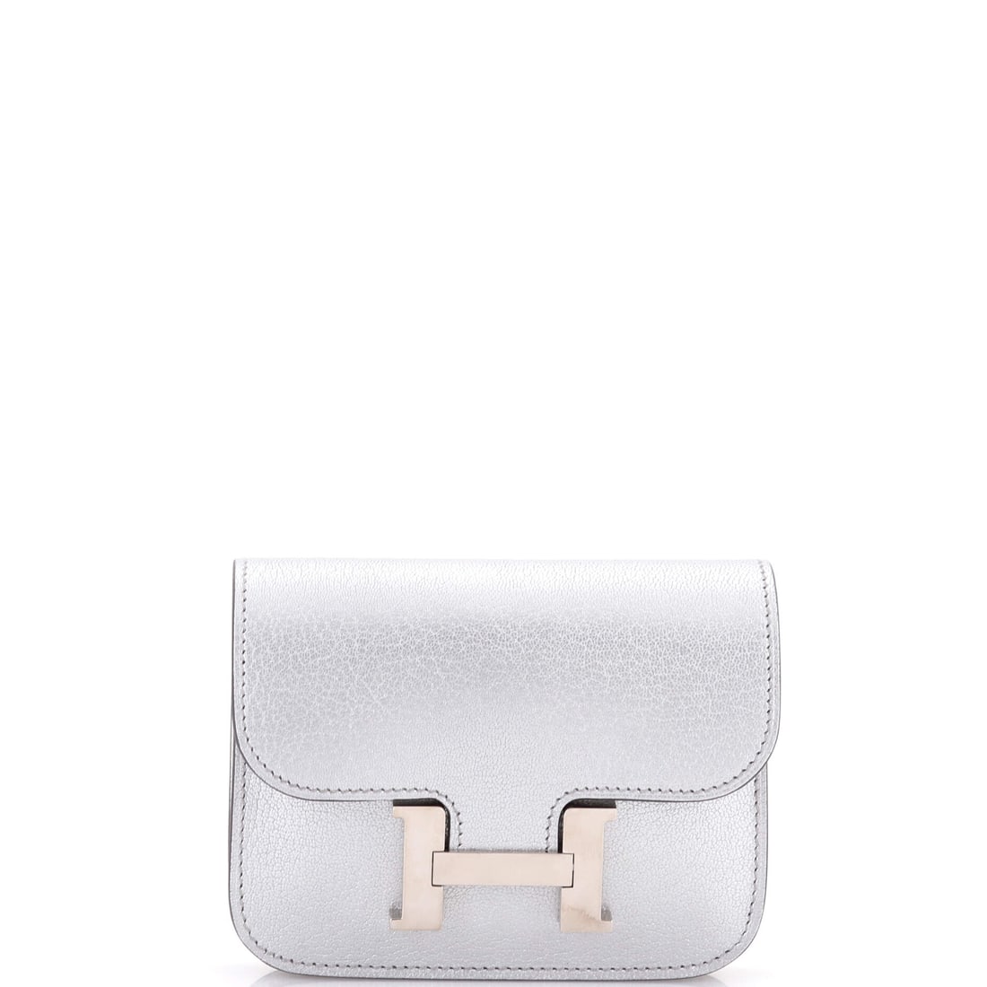 Hermes Constance Slim Wallet Chevre Chamkilight: The Hermes Constance Slim Wallet in Chevre Chamkilight translates the house's larger-bag architecture into a piece small enough to carry alongside it. Chamkilight is one of Hermes's luminous metallic 