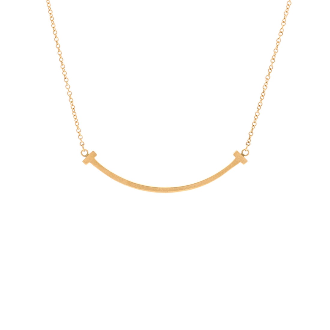 Tiffany & Co. T Smile Pendant Necklace 18K Yellow Gold (Small): The Tiffany & Co. T Smile Pendant Necklace carries the 18k yellow gold treatment across 15.8 inch length. 18K Yellow Gold sits among the more wearable readings of the Tiffany & Co. jewelry catalogue, 
