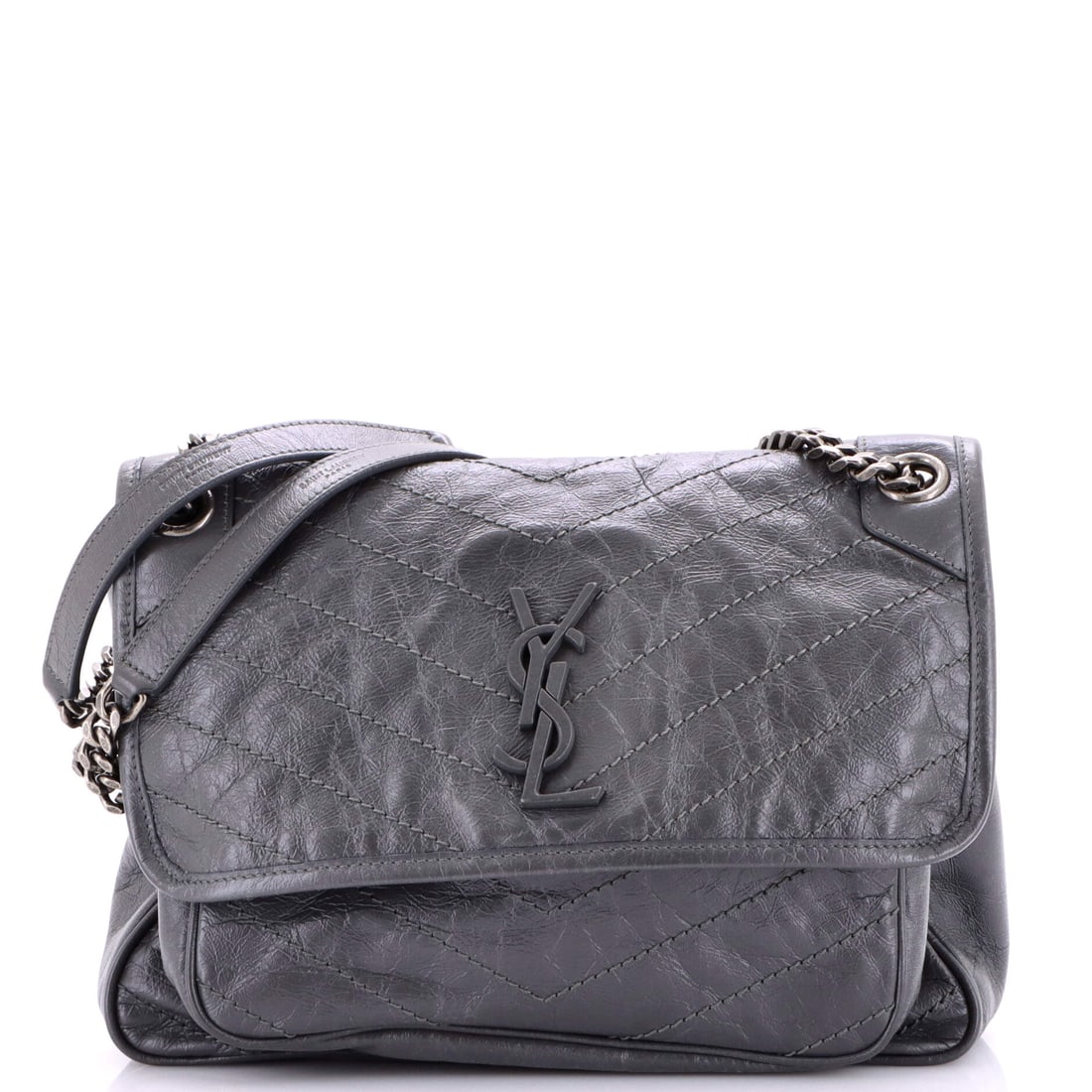Saint Laurent Niki Chain Flap Bag Matelasse Chevron Leather (Medium): The Saint Laurent Niki Chain Flap Bag in Matelasse Chevron Leather is the model in its most architecturally legible reading. Matelasse is the quilted, padded stitching technique that gives a leather s